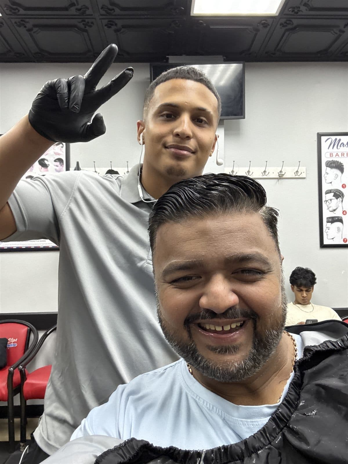 Barber and client after a fresh haircut at Master Clips