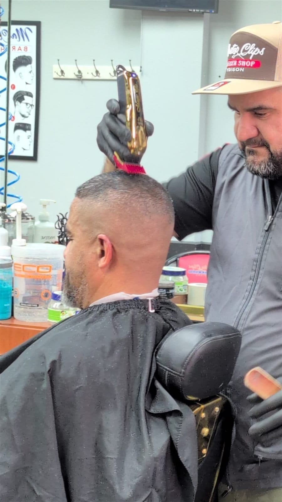 Barber creating a clean fade with clippers at Master Clips Barber Shop