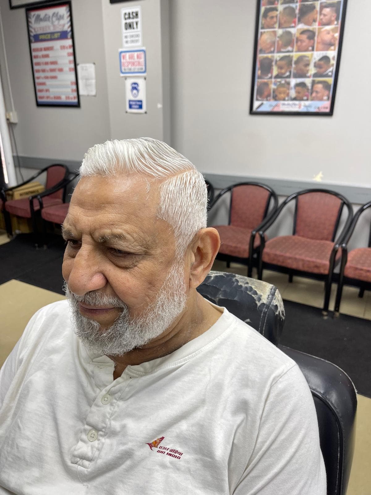 Classic silver haircut and neatly groomed beard for a mature client