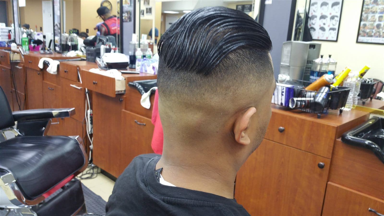 Slicked-back haircut with a close skin fade