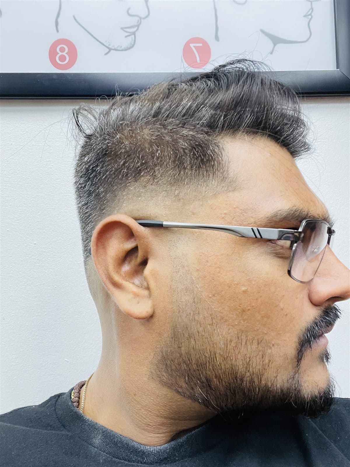 Textured top haircut with a clean skin fade